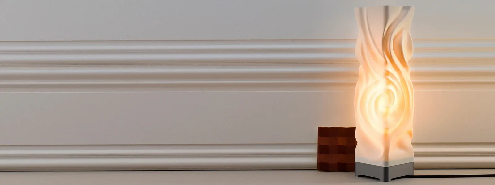 Decorative floor lamp with wavy design against a white wall