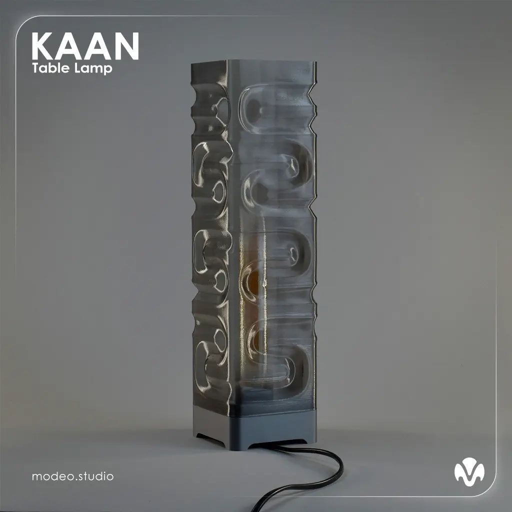 Gray textured table lamp with 'KAAN' branding on a gray background with the light turned of. Created by MODEO Design