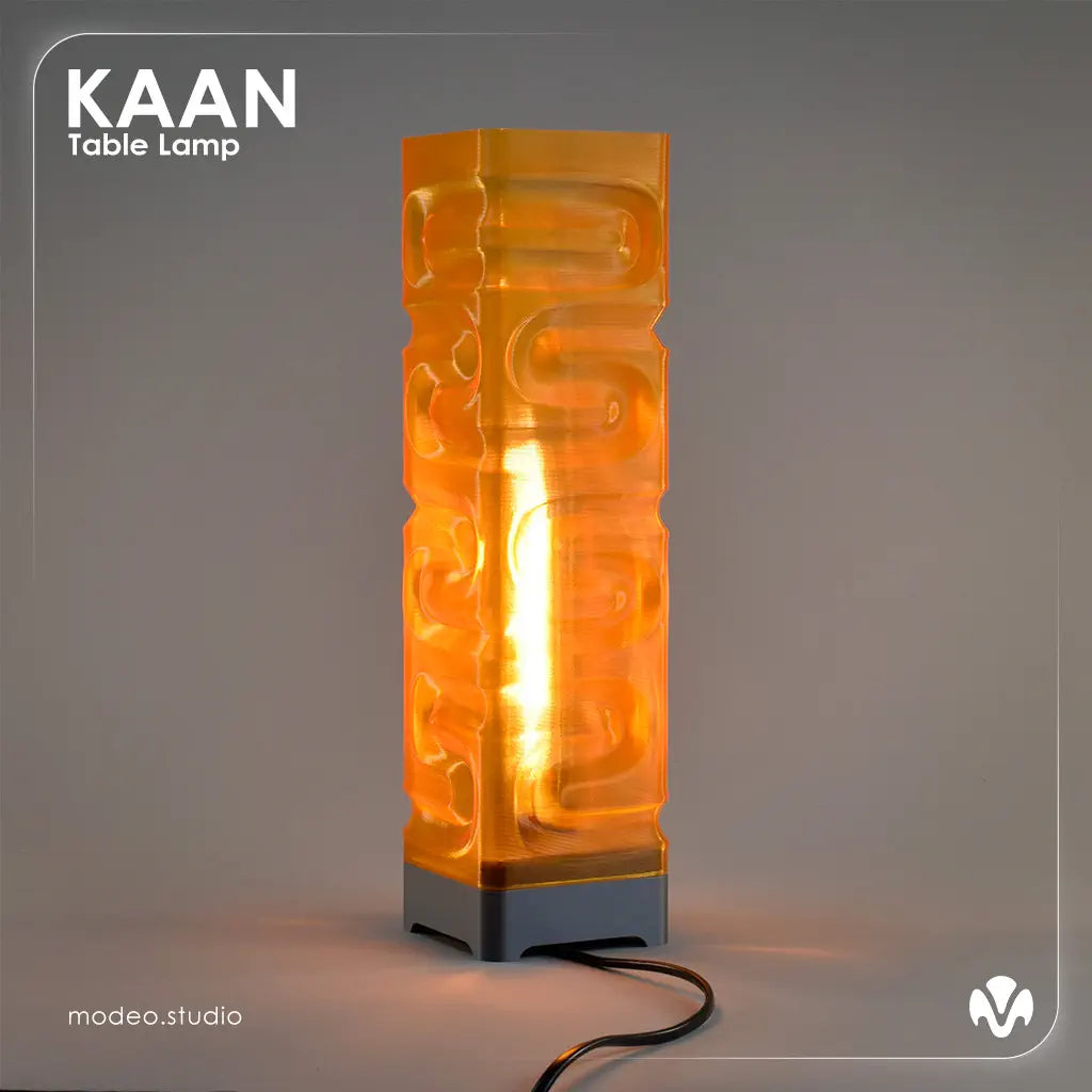 Orange translucid textured table lamp with 'KAAN' branding on a gray background with the light turned on. Created by MODEO Design